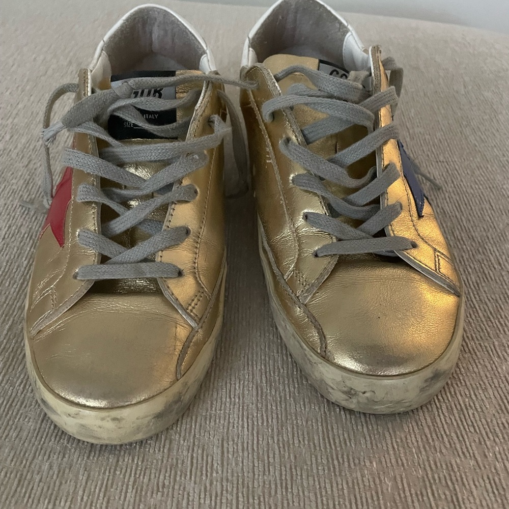Golden Sneakers with Red and Blue Accents